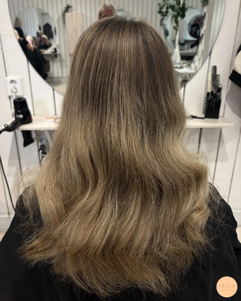 Kall beige blond hårfärg med ljusa slingor och bevarad naturlig botten